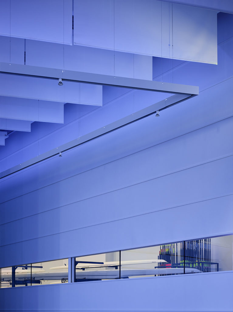 Blue-lit interior architectural detail at the CHK | UCO Boathouse